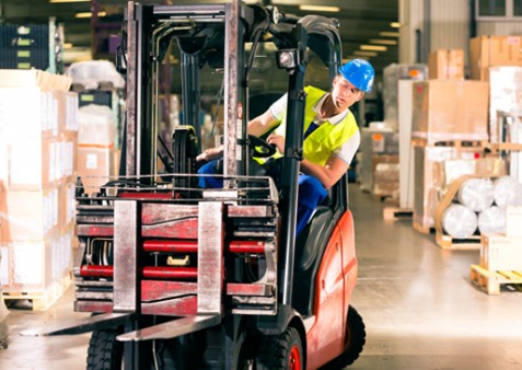 A forklift truck driver in a warehouse